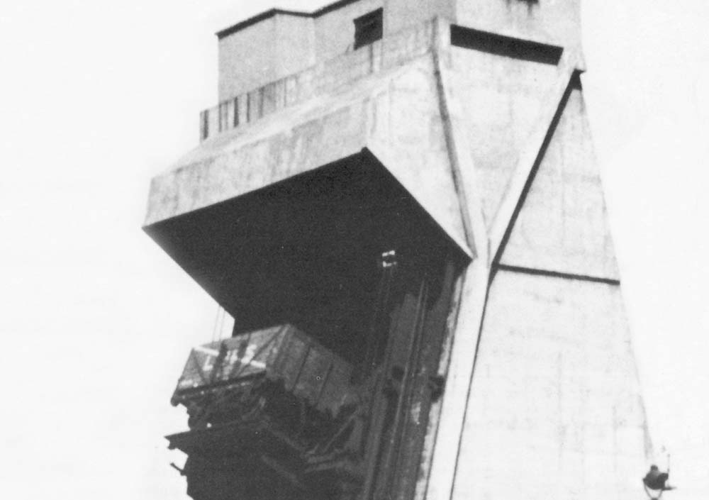 Close up of the wagon being raised on the hoist with chains in place to secure the wagon for when it was rotated at the top for discharging