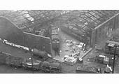 An early 1950s view of the war damaged corner to Saltley Shed's No 3 roundhouse showing a variety of ex-LMS goods locomotives around the turntable