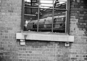 BR Standard Class 9F locomotives are seen through the window of Saltley shed's No 3 roofless roundhouse