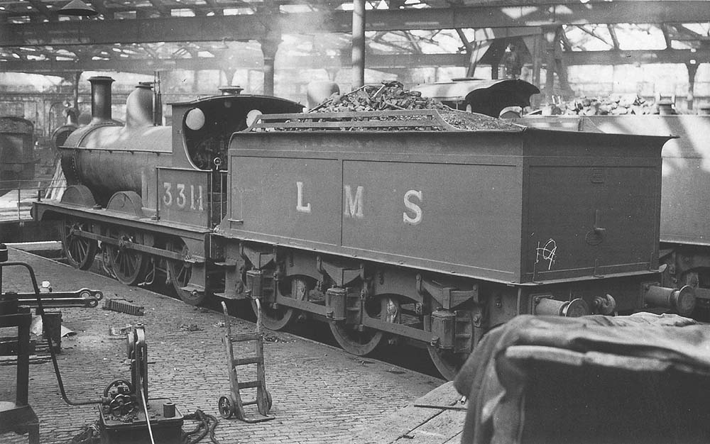 Ex-Midland Railway 2F 0-6-0 No 3311 stands inside one of Saltley shed's three roundhouses