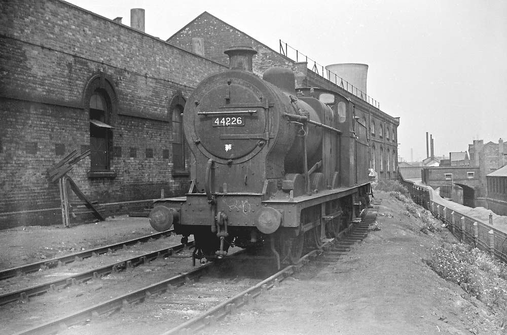 Ex-LMS 4F 0-6-0 No 44226 is seen standing on the scrap line at the rear of Saltley shed adjacent to the canal