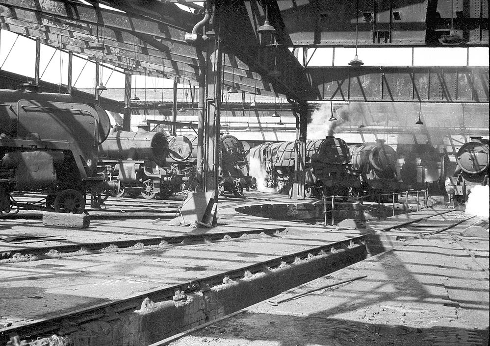 Seven British Railways and ex-LMS locomotives are seen disposed around the turntable of Saltley shed's No 3 roundhouse