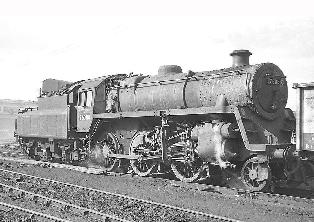 British Railways Standard Class 4MT 2-6-0 No 76088 gently simmers whilst standing in front of Saltley's No 3 roundhouse on 25th March 1964