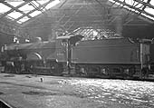 Ex-LMS 4P 4-4-0 No 41140 stands inside the roofless part of Saltley shed on 27th February 1955