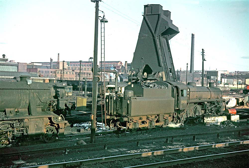 British Railways Standard Class 4MT 4-6-0 No 75000 stands with a couple of ex-LMS 8F 2-8-0 locomotives on 31st July 1967