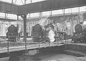 General view inside Saltley No 3 roundhouse with three BR Standard Class 9F 2-10-0 locomotives on view