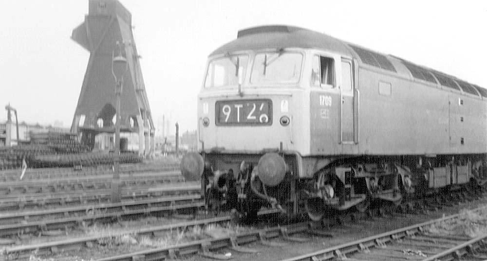 British Railways Bush Traction Type 4 Co-Co D1709 stands outside Saltley shed in July 1969 as in the background track is being lifted