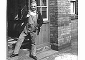 Bristol Barrow Road Driver Gordon Evans stands at the entrance to Saltley Lodging House in 1964