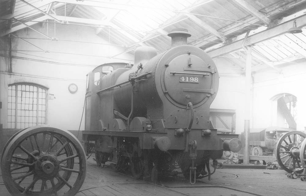 LMS 4F 0-6-0 No 4198 is seen on Friday 9th September 1932 standing in the fitting shop minus its tender but still carrying its lamp from its last trip