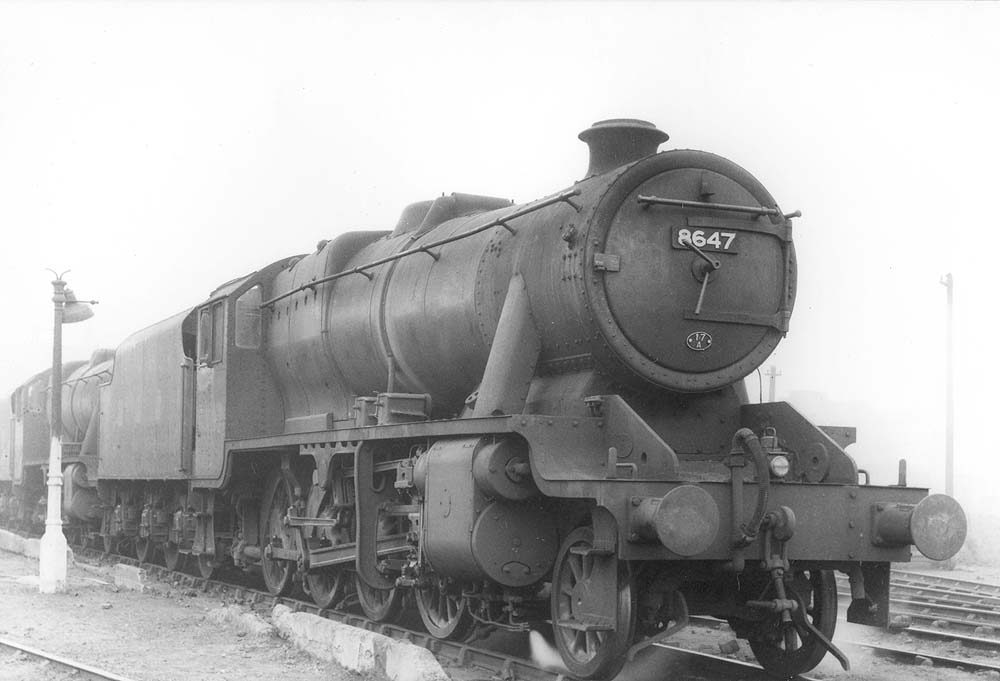 LMS 8F 2-8-0 No 8647 sports a 17A Derby shed plate whilst standing in front of another classmate on one of Saltley's stabling roads