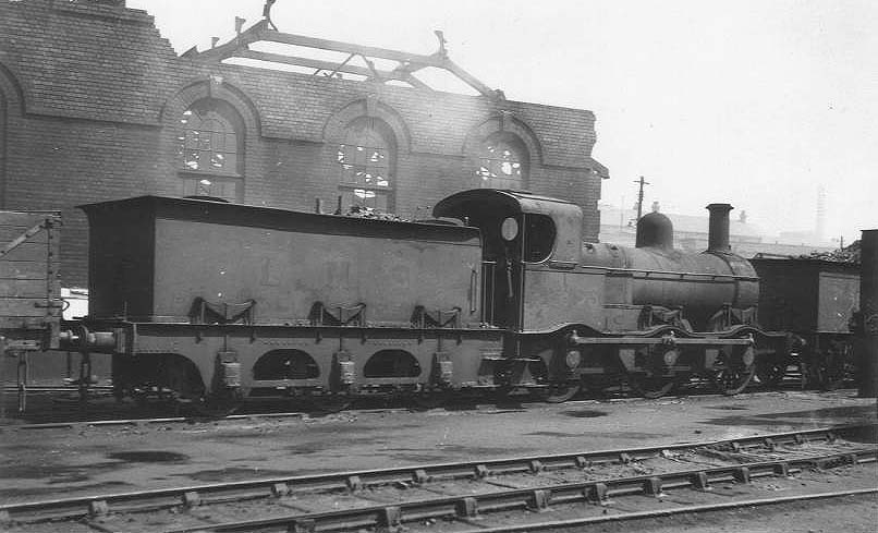 Ex-MR 2F 0-6-0 No 22853, a MR 700 class locomotive, is seen standing adjacent to the war time damaged corner of Saltley shed's No 3 roundhouse