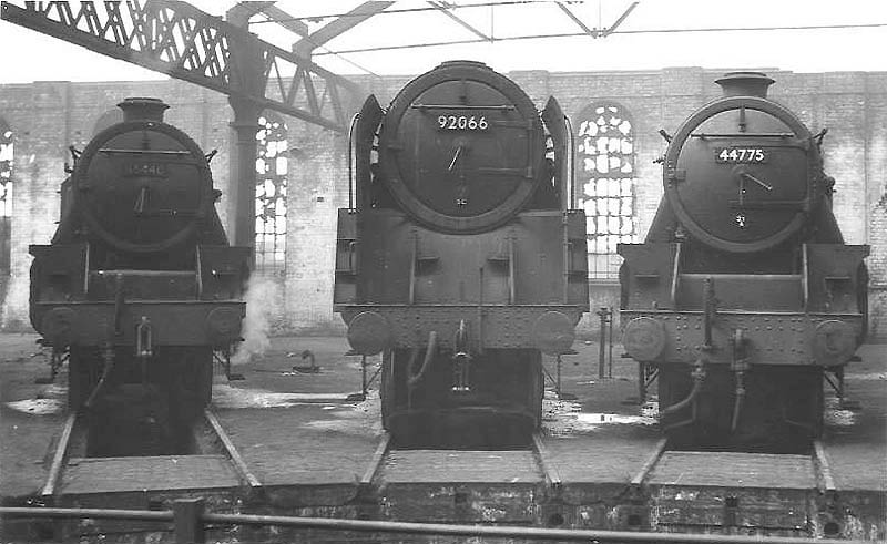 BR 9F 2-10-0 No 92066 in company with ex-LMS 5MT 4-6-0s No 44775 and No 45440 on the stabling roads inside Saltley shed's No 3 roundhouse