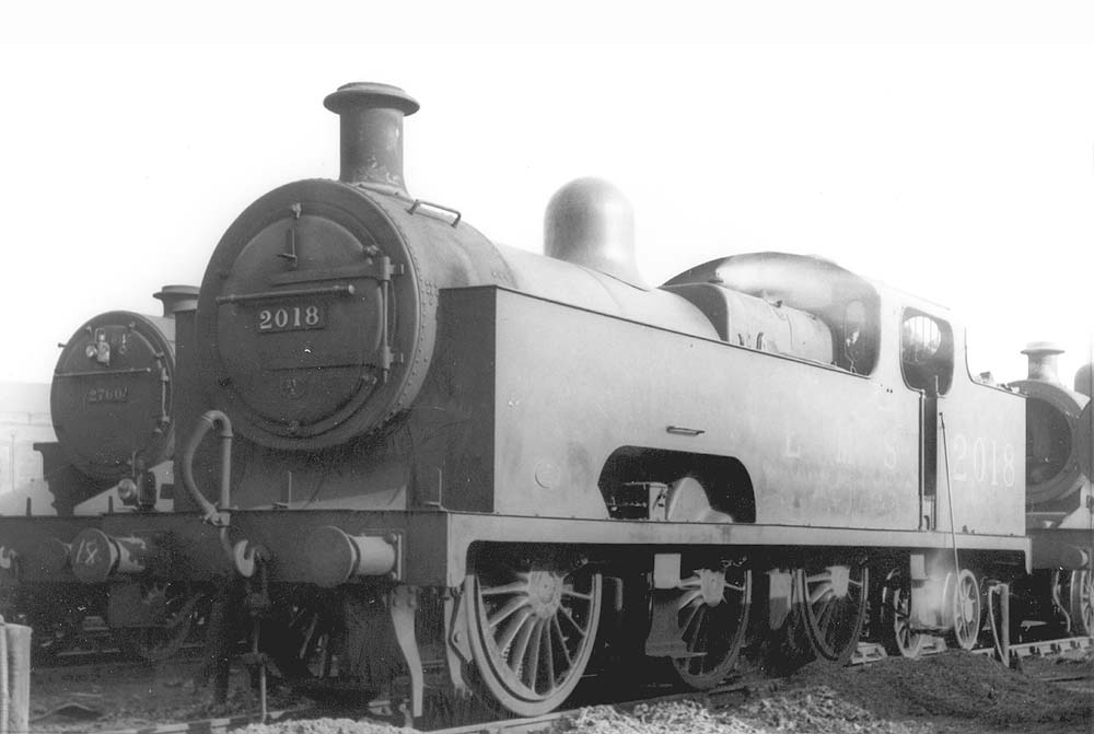 Ex-MR 3P 'Flatiron' No 2018 is seen during its disposal as is evident by the fire iron leaning against the cab and the ash lying adjacent to the track