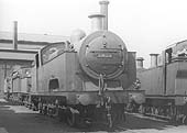Ex-MR 0-6-4T 'Flatiron' No 2025 is standing alongside an unidentified 0-6-0T 'Jinty' on one of the stabling roads outside Saltley's No 3 roundhouse