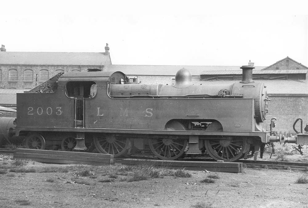 Ex-MR 0-6-4T 'Flatiron' No 2003 is seen standing at Saltley shed with coaled piled high on the bunker with boarding used to retain the poor quality coal