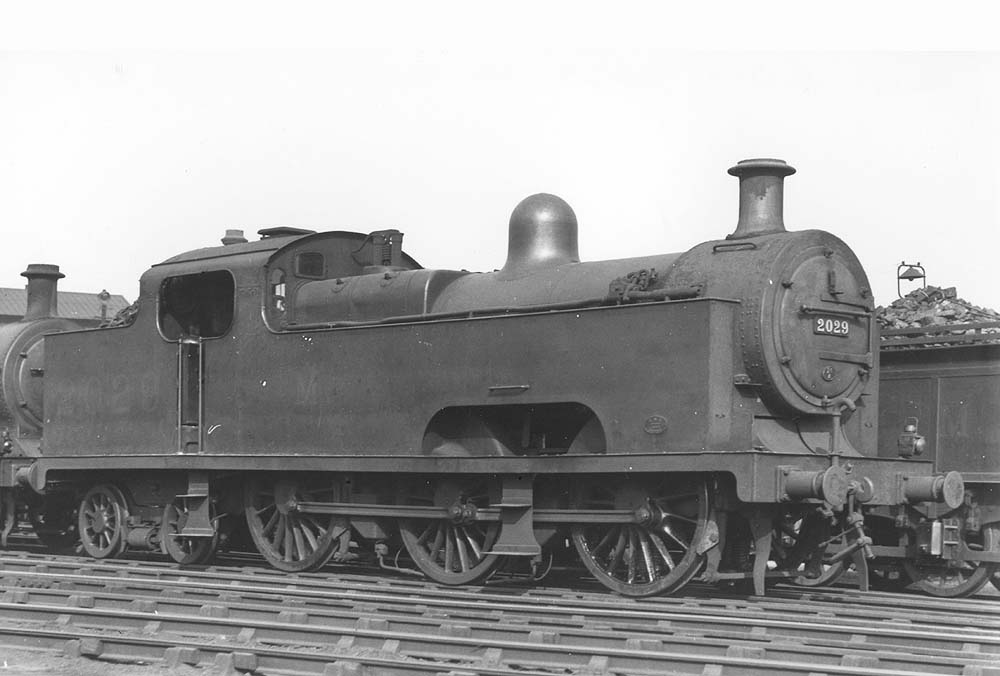 Ex-MR 3P 0-6-4T 'Flatiron' No 2029 is seen standing in line on one of Saltley shed's stabling roads outside No 3 roundhouse