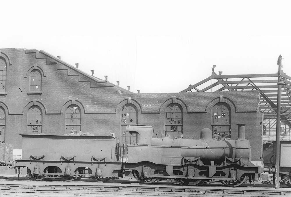 Ex-MR Kirtley 2F 0-6-0 No 22853, complete with outside curved frames, is seen standing alongside the war-damaged corner of No 3 roundhouse