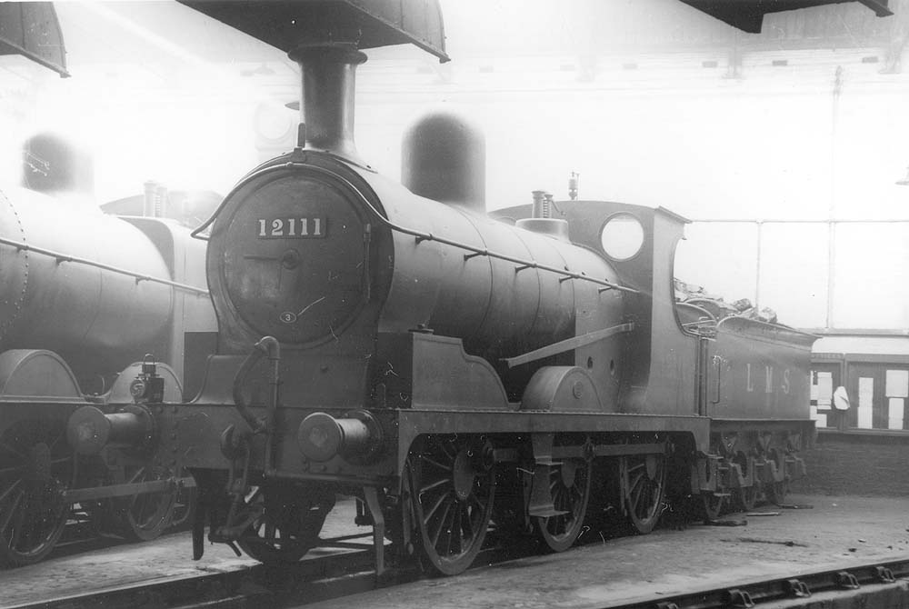 View of an ex-Lancashire & Yorkshire Railway 3F 0-6-0 No 12111 on Saturday 24th September 1932 inside one of Saltley shed's roundhouses