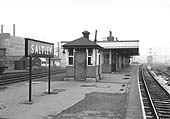 Looking towards Water Orton along Saltley station's down platform with Saltley Sidings Signal Box and adjacent sidings in the distance