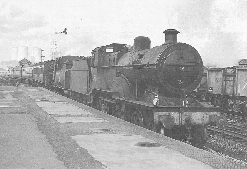 Ex-MR 4-4-0 2P No 40511 pilots British Railways built 2-6-0 4MT No 43017 running tender first through the station