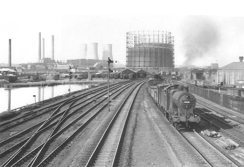 Ex-LMS 4F 0-6-0 No 44538 heads a down express freight on the down passenger line on 8th August 1955