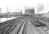 Ex-LMS 4F 0-6-0 No 44538 heads a down express freight on the down passenger line on 8th August 1955