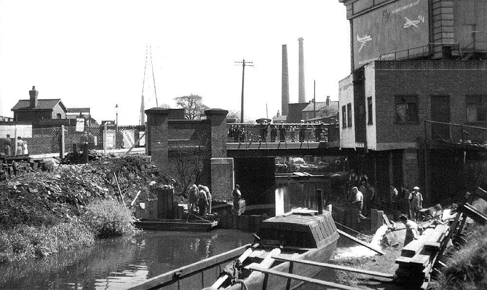 View of the Worcester - Birmingham Canal being drained adjacent to Bristol Road bridge during May 1955