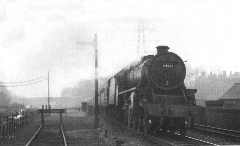 Ex-LMS 4-6-0 'Black 5' No 44920 is seen working an express service 'wrong road' on 17th February 1957
