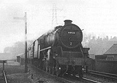 Ex-LMS 4-6-0 'Black 5' No 44920 is seen working an express service 'wrong road' on 17th February 1957