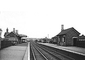 A black and white version of Selly Oak station looking towards Birmingham New Street station