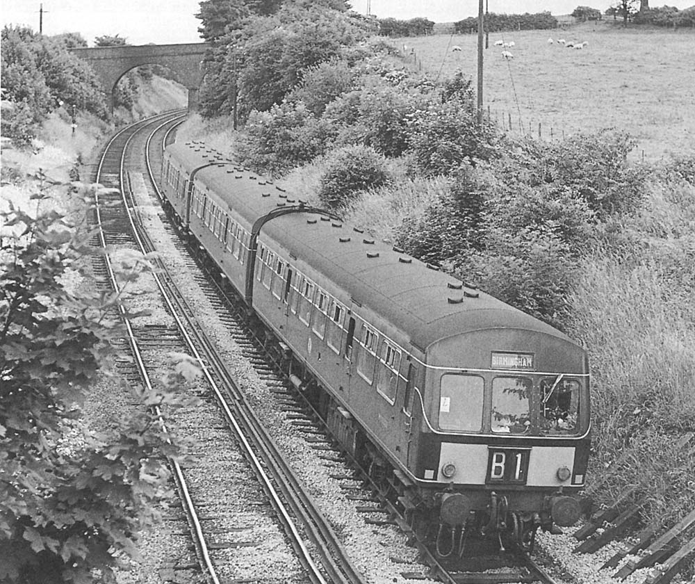 Looking towards Nuneaton as a three-car Metro-Cammell DMU arrives on the 13:28pm Peterborough to Birmingham service on Sunday 26th June 1966