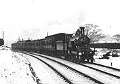 An unidentified MR Single 4-2-2 at the head of a train of mixed of rolling stock