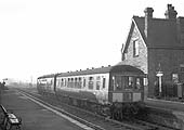 A two-car DMU is seen arriving on the diverted 1:10pm New Street to Rugby local train on 8th December 1963