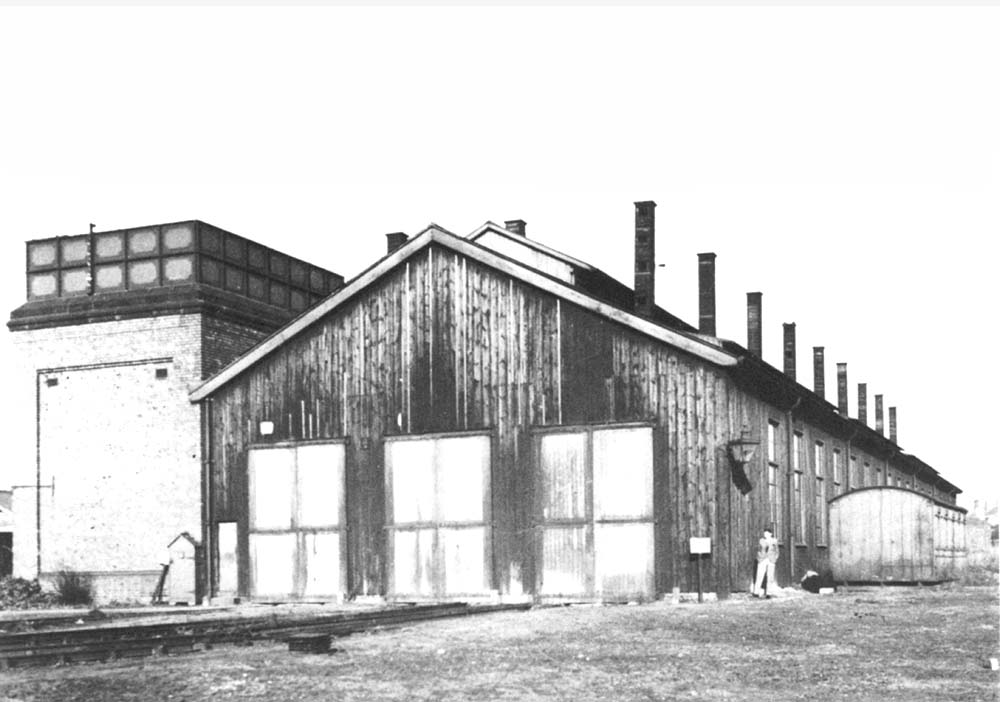 External view of Stockingford's closed shed showing the large water tank supported by brick walls and the main shed building constructed from timber
