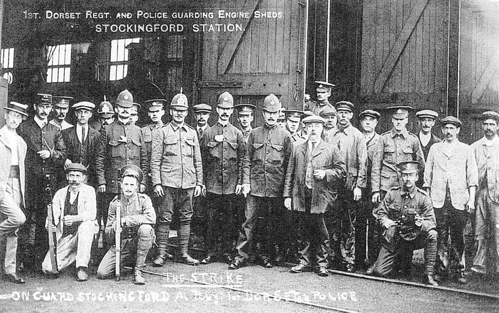 Railway police and staff pose with soldiers of the 1st Dorset Regiment outside Stockingford Shed in 1911