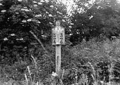 A mile post sign mounted on top of some early Victorian rail near Coleshill station on 8th July 1951