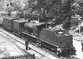 Close up showing LMS 4F 0-6-0 No 4069 coupled to a Midland Brake Van and six-wheel coach