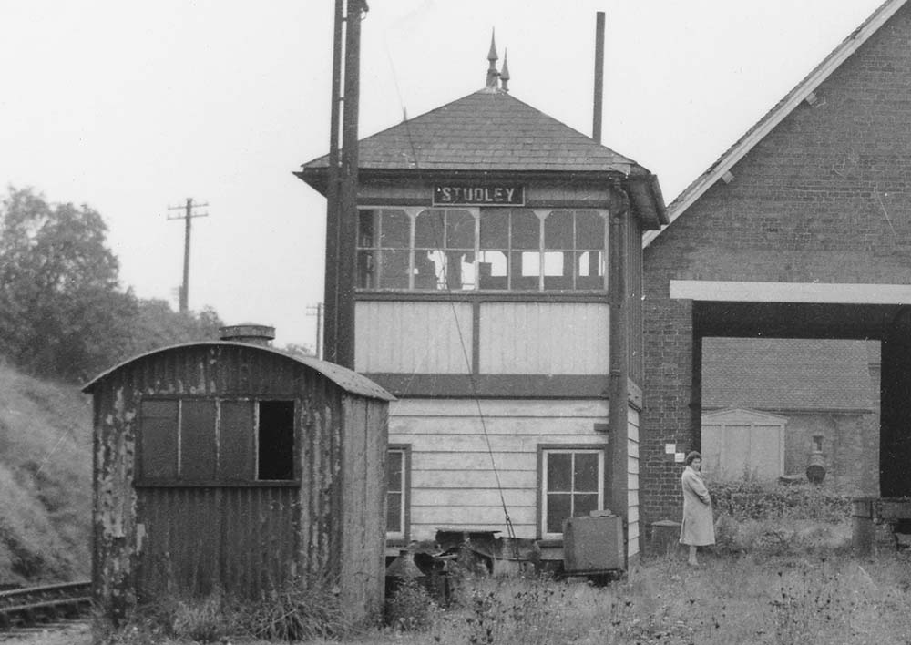 Close up showing the oil storage hut and Studley Signal Box with the ground in between littered with cans