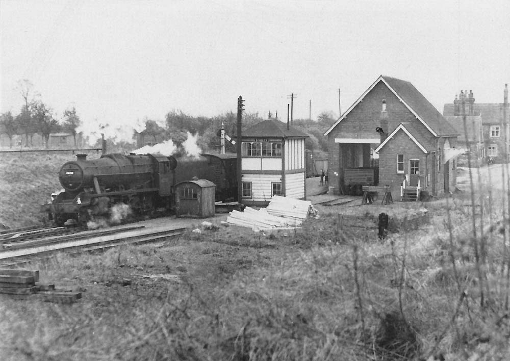Ex-LMS Stanier 8F 2-8-0 No 48700 passes Studley & Astwood Bank station on a northbound stopping train