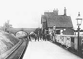 Looking towards Alcester along the single line platform with both passengers and staff posed for the camera