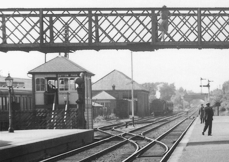 Close up showing Sutton Park signal box and goods yard and shed with a passenger train standing in siding
