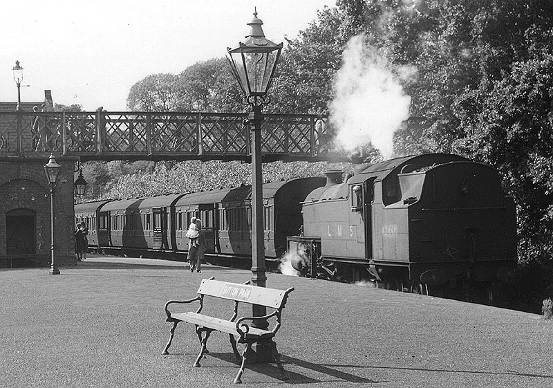 Close up showing ex-LMS 4MT 2-6-4T No 42448 running bunker first on a train to New Street station