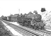 Ex-LMS 5MT 4-6-0 No 45464 picks up water from Tamworth water troughs whilst at the head of a down parcels train circa 1963