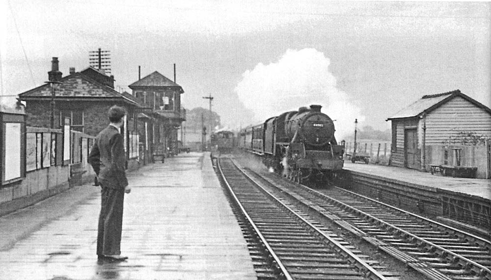 Looking north towards Derby as a goods train is seen departing the station as an ex-LMS 5MT 4-6-0 passes through on a down express service