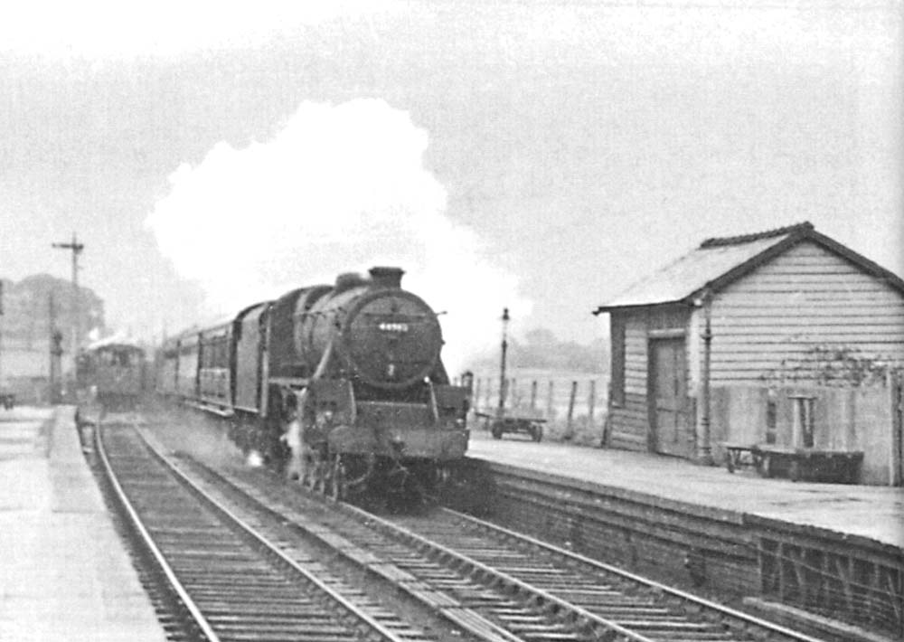 Close up showing the unidentified ex-LMS 4-6-0 5MT storming through the station on a down express service