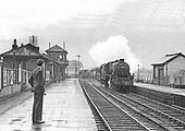 Looking towards Derby as a goods train departs the station as an ex-LMS 5MT 4-6-0 passes