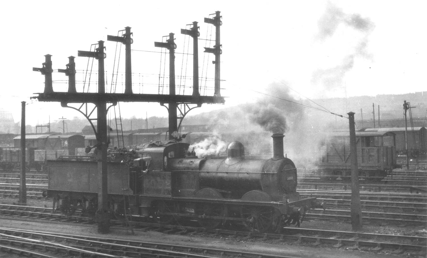 Ex-Midland Railway 0-6-0 2F No 3052 is seen emitting a lot of dirty smoke whilst standing on the down goods line at Washwood Heath Sidings circa 1948