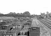 Close up showing a variety of timber mineral wagons and a mixture of types of vented vans