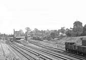 Close up showing Water Orton station's goods yard on the right with many vehicles evident on both sidings