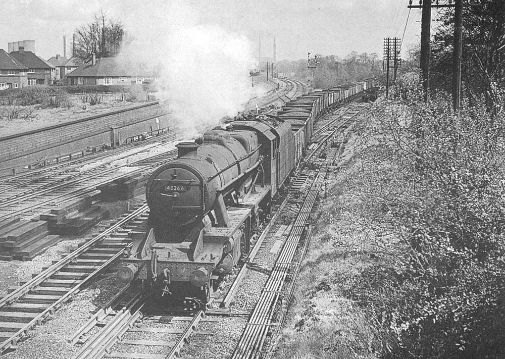Ex-LMS 2-8-0 8F No 48266 leaves the Leicester line on a coal train to Washwood Heath on Saturday 26th April 1958